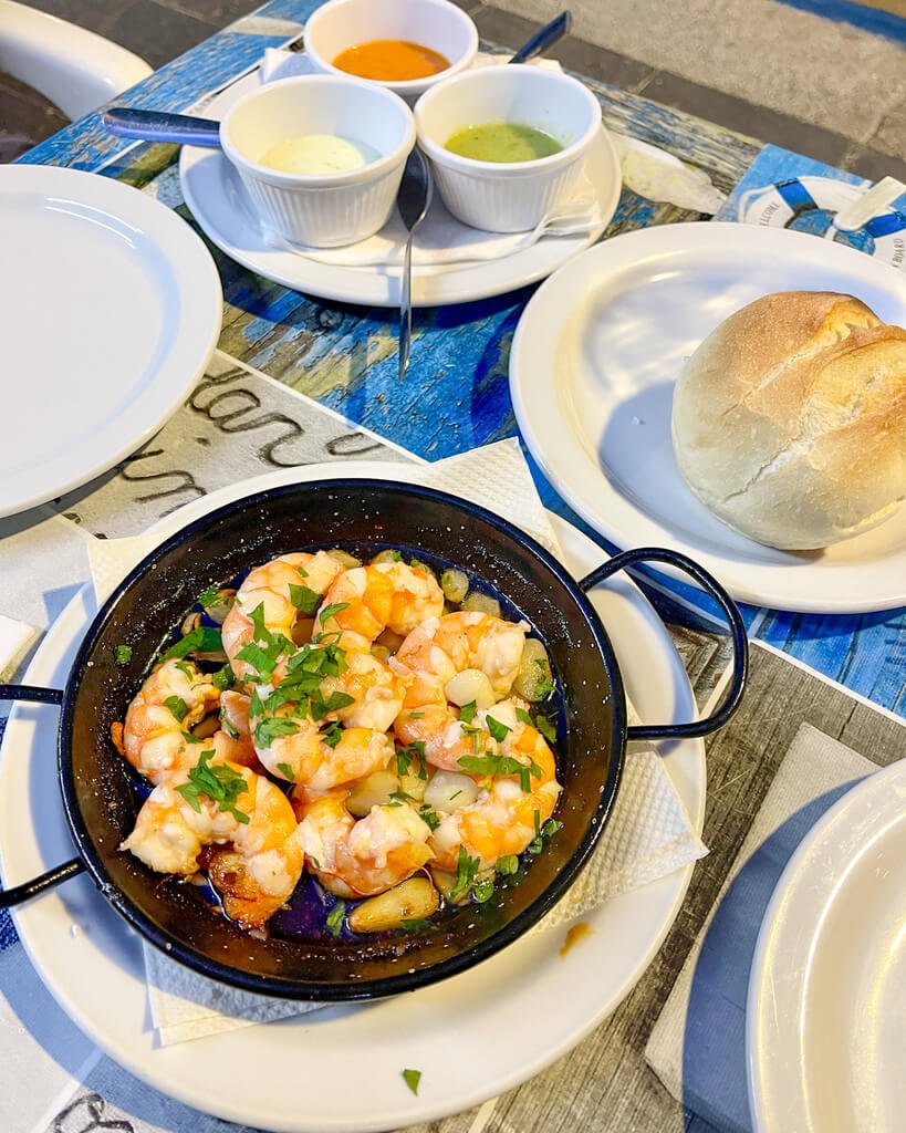 Reker stekt i olje og hvitløk, brød, aioli og ulike sauser på taverna i Corralejo. 