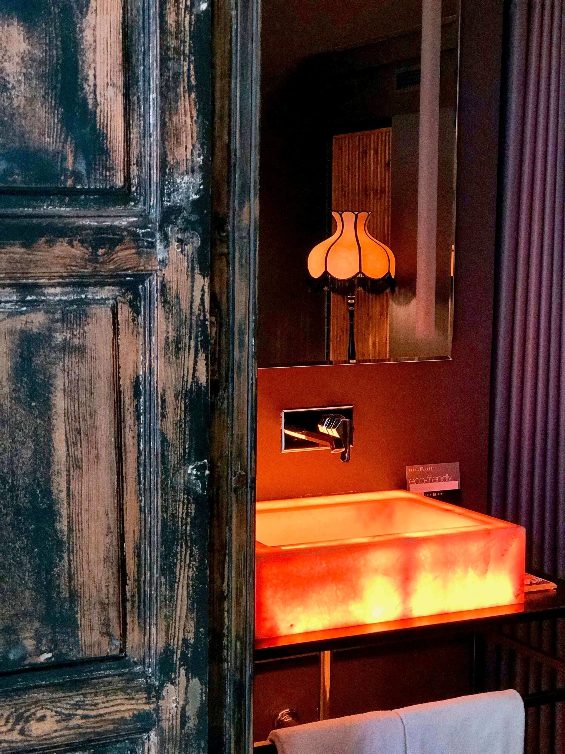 Hotel Lobby bathroom with a sink that lights up. 