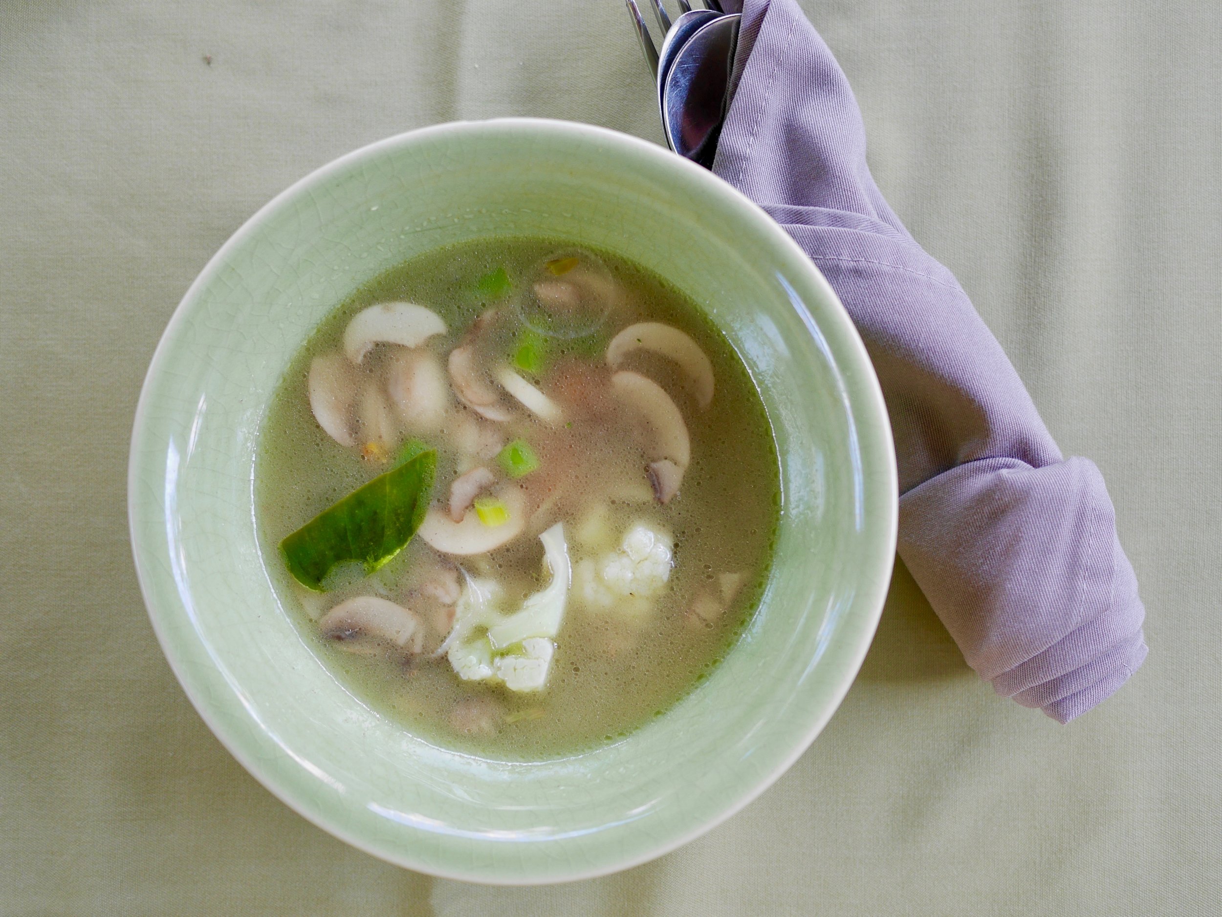 Balinese soup Kuah Wong served in a green bowl. 