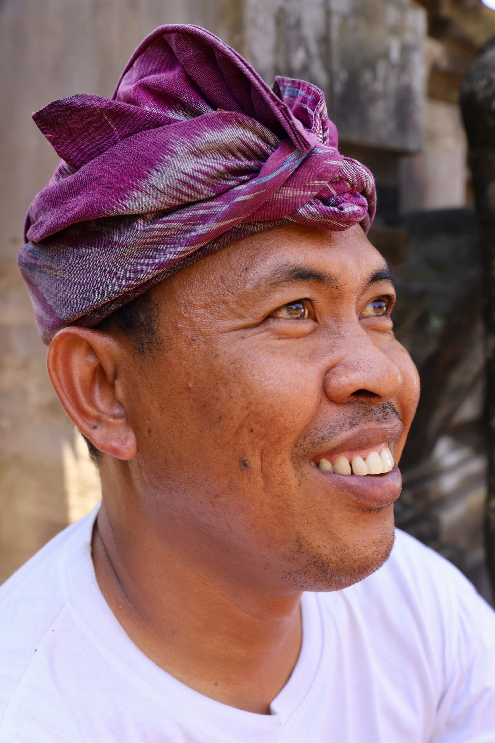 Local beautiful man with a purple hat in Ubud Bali.