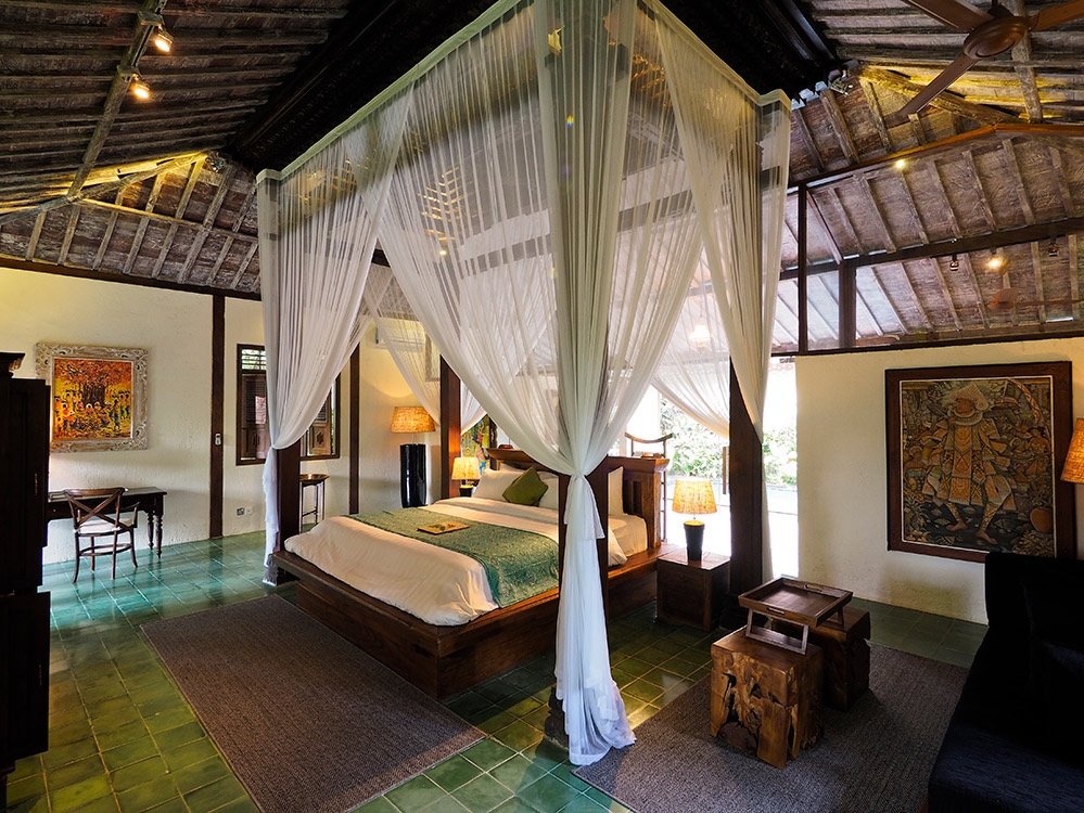 Plataran Bali Canggu Hotel room with big bed and traditional Bali style furniture. 