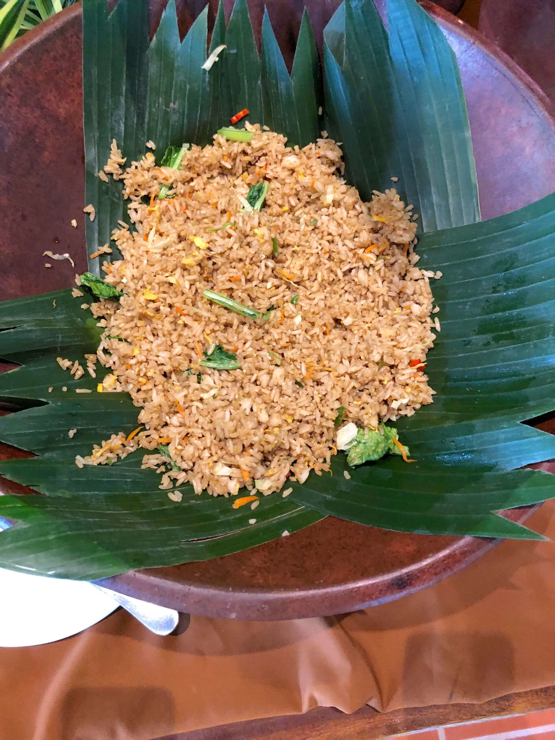 Traditional balinese food, rice served on palm leafs. 