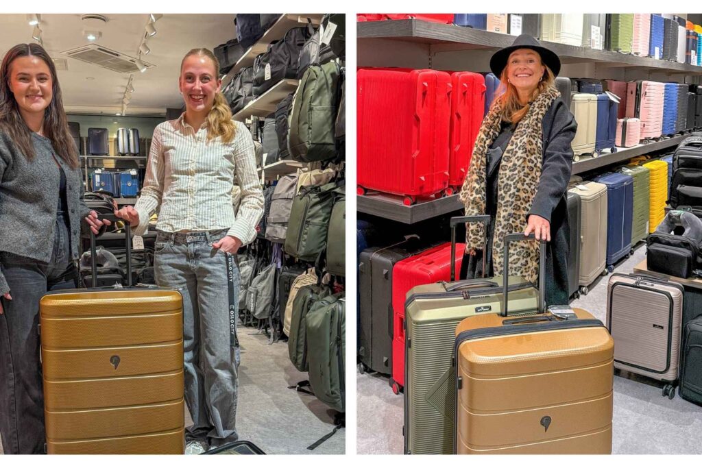 North Pioneer kofferter i butikk omgitt av reiseutstyr og bagasje. En smilende kunde og to smilende selgere. 