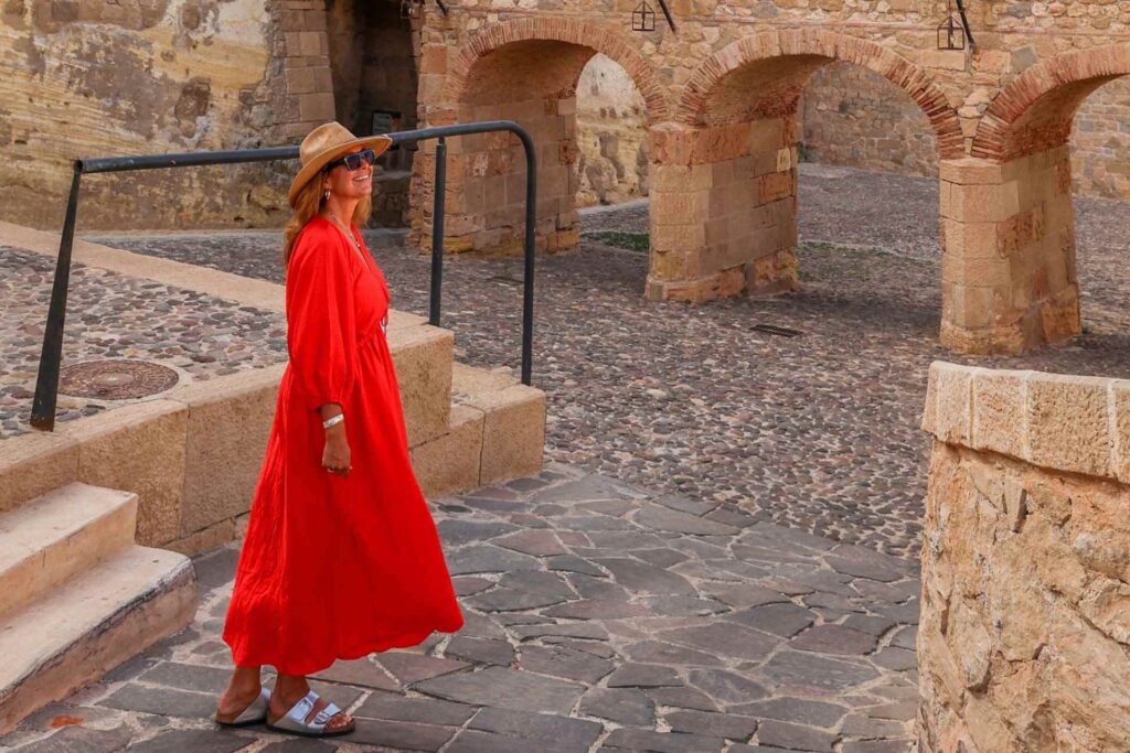 I Melilla la Vieja, den historiske festningsbyen i Melilla, dame med hatt p&aring; hodet og r&oslash;d kjole. 